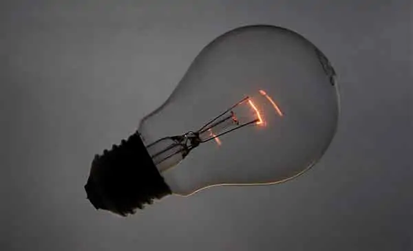 Incandescent tungsten light bulb glows orange