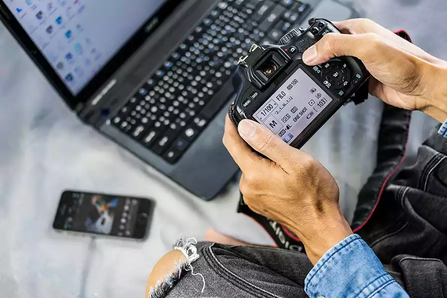 Photographer looking at the settings screen on his Canon DSLR