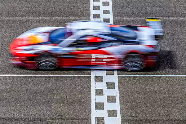 Sample image of a racing car with motion blur because it was shot with a low shutter speed in  shutter priority mode