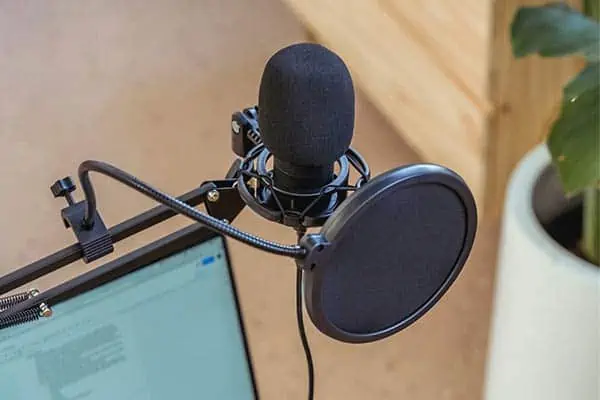A pop filter used together with a windscreen to prevent popping