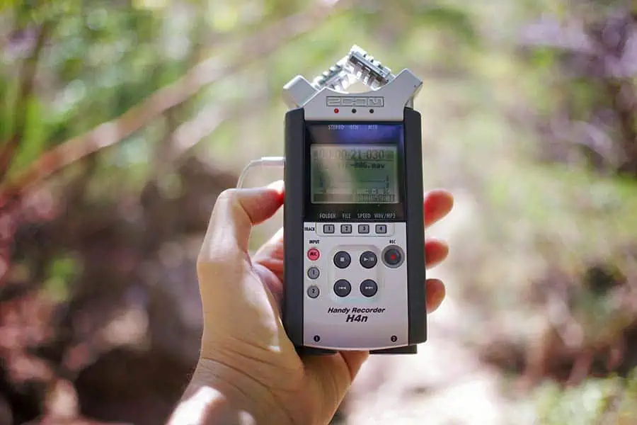 A Zoom H4n audio recorder held in hand