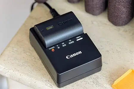 A Canon LP-E6NH Li-Ion battery charging