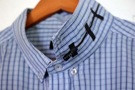 The lavalier microphone is hidden under a shirt collar