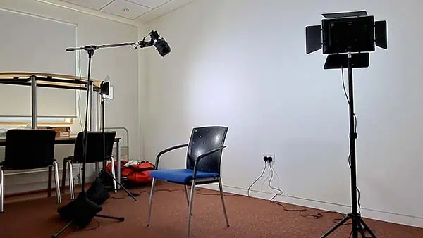 Image showing the background wall illuminated by LED lights and a microphone setup where the subject will sit