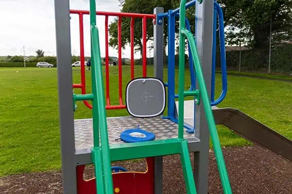 Gray card places on a playpark climbing frame and slide