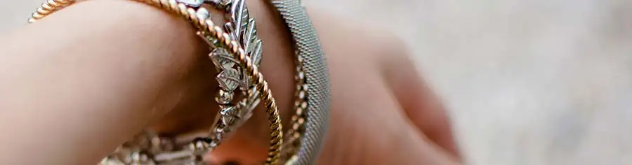 Layered metal bracelets on a womans wrist