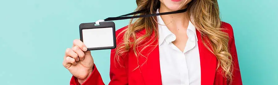 Woman taking off an ID badge on a lanyard