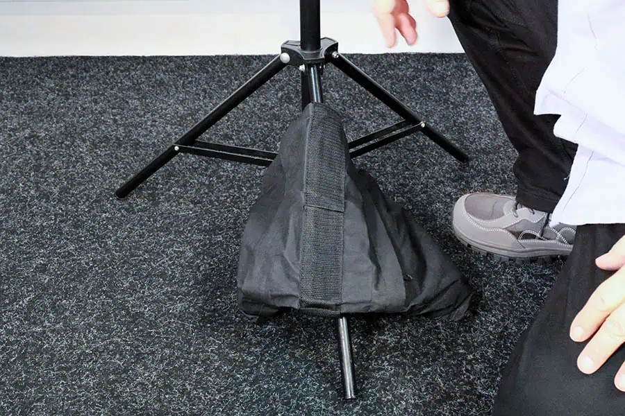 Incorrect sandbag placement on a light stand resting on the floor